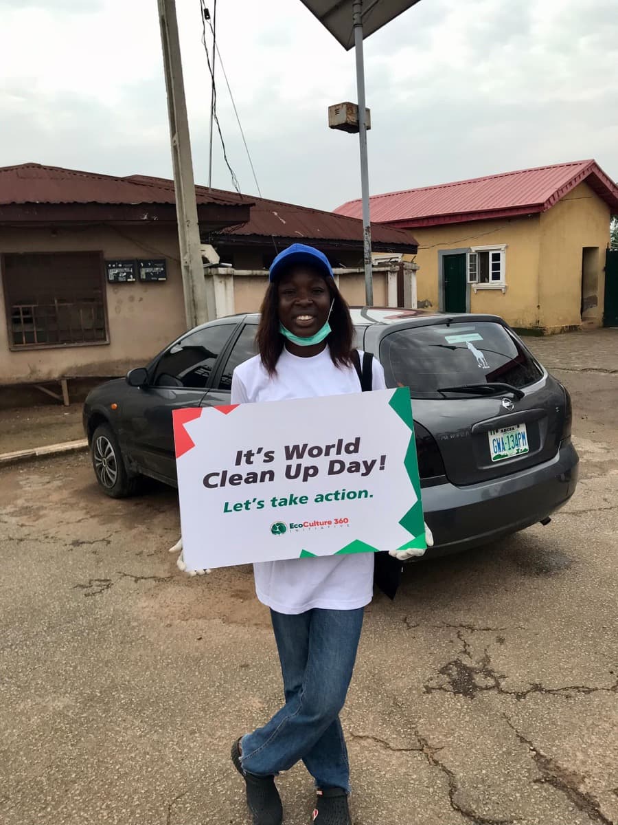 Volunteer with World Clean Up Day sign