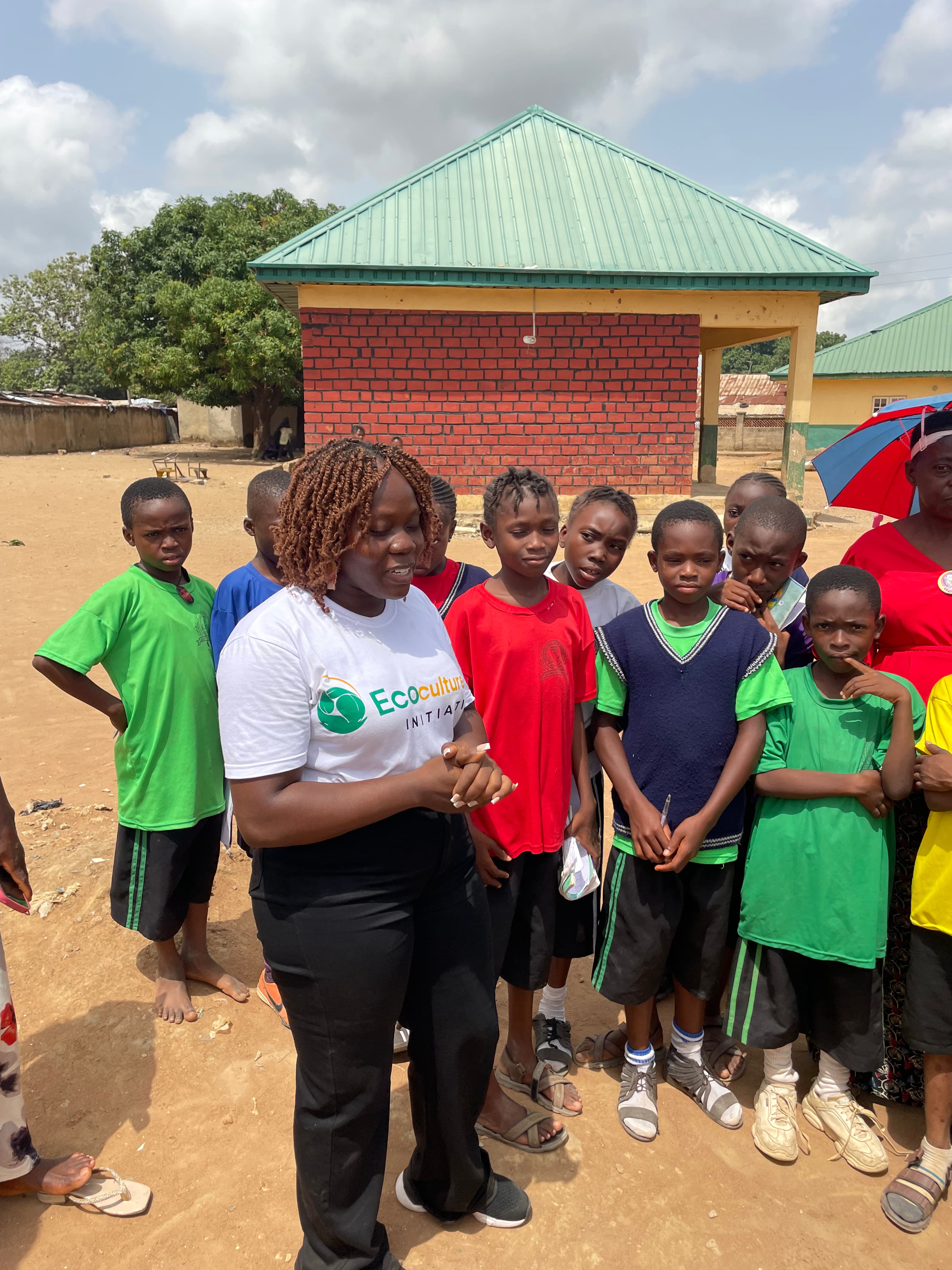 Youth volunteers planting trees in a sunny field